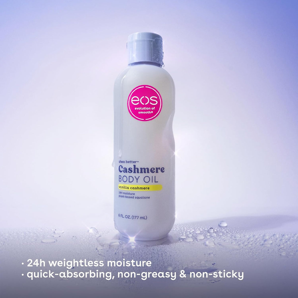 eos Shea Better Cashmere Body Oil i vanilla cashmere-duft, hvid flaske med pink logo på våd overflade.