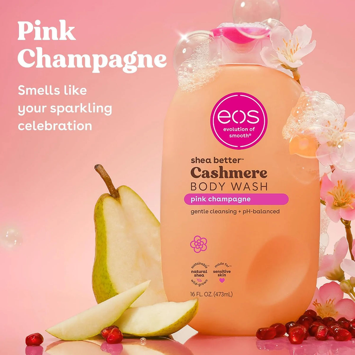eos Shea Better Cashmere Body Wash i Pink Champagne-duft, flaske omgivet af pærer og granatæblekerner.
